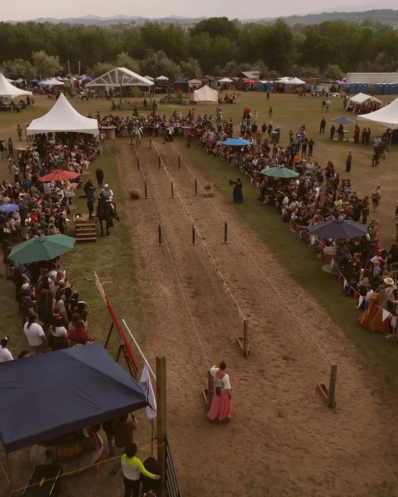 Aerial view of the festival procession walking the jousting lane between the crowds
