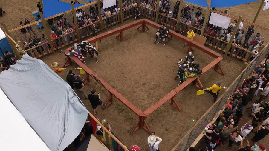 Three simultaneous armored bouts at the corners of the combat arena, seen from above