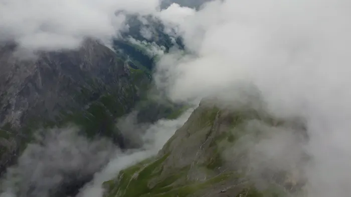Cloud pouring over a mountain gorge above the Limmernsee, Switzerland