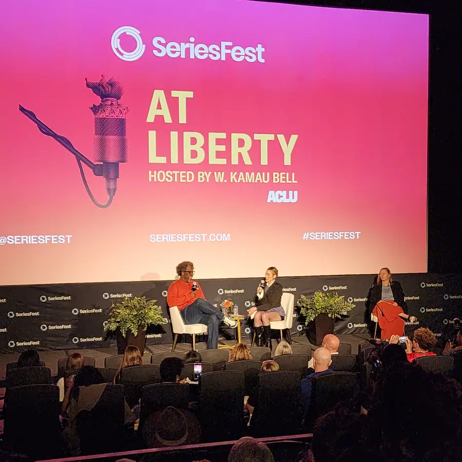Four people seated on the SeriesFest stage below a pink screen reading “At Liberty, hosted by W. Kamau Bell, ACLU.”