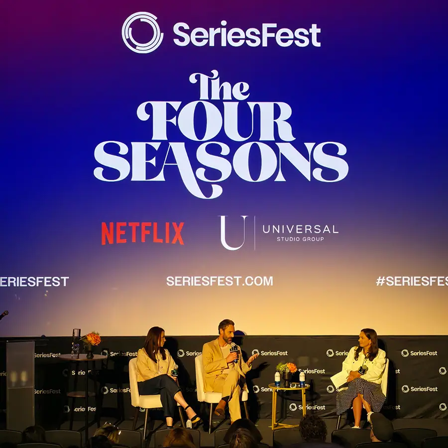 Three panelists seated on the SeriesFest stage under a screen reading “The Four Seasons,” with the Netflix and Universal Studio Group marks.