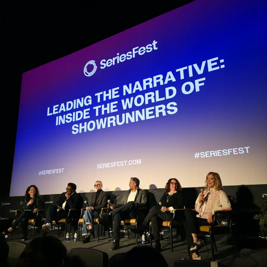 Six panelists seated on the SeriesFest stage beneath a screen reading “Leading the Narrative: Inside the World of Showrunners.”
