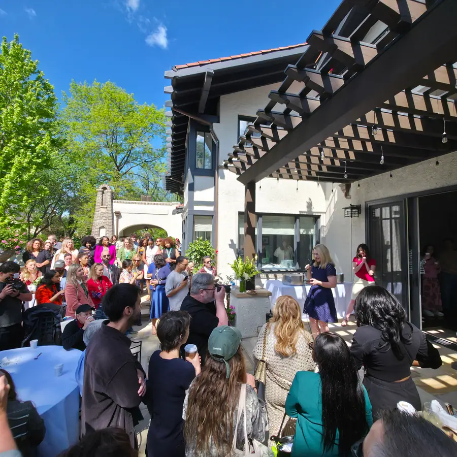 A crowd gathered on a sunlit patio at a SeriesFest weekend gathering.