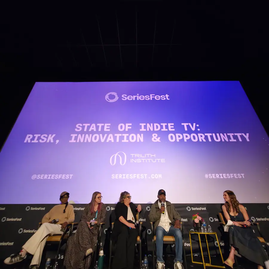 A panel of five, the screen behind reading State of Indie TV: Risk, Innovation & Opportunity.