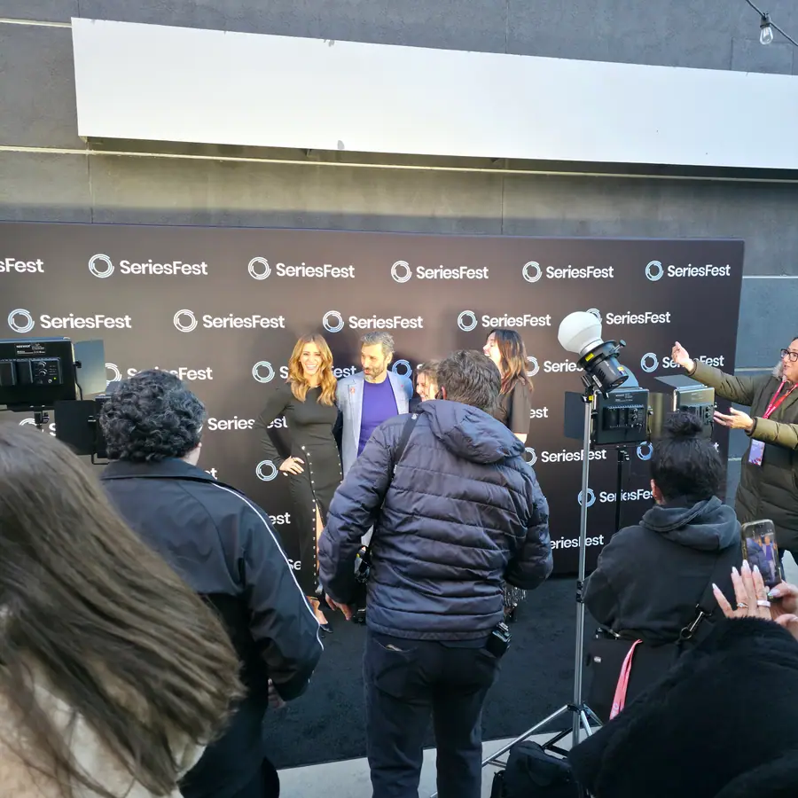 Photographers and press gathered in front of the branded SeriesFest step-and-repeat.