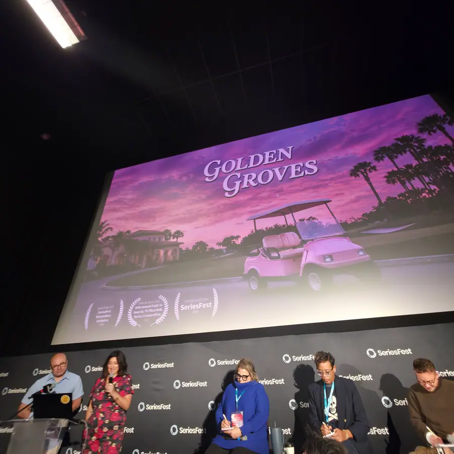 An official-selection pilot on the big screen, a panel seated below for the post-screening Q&A.