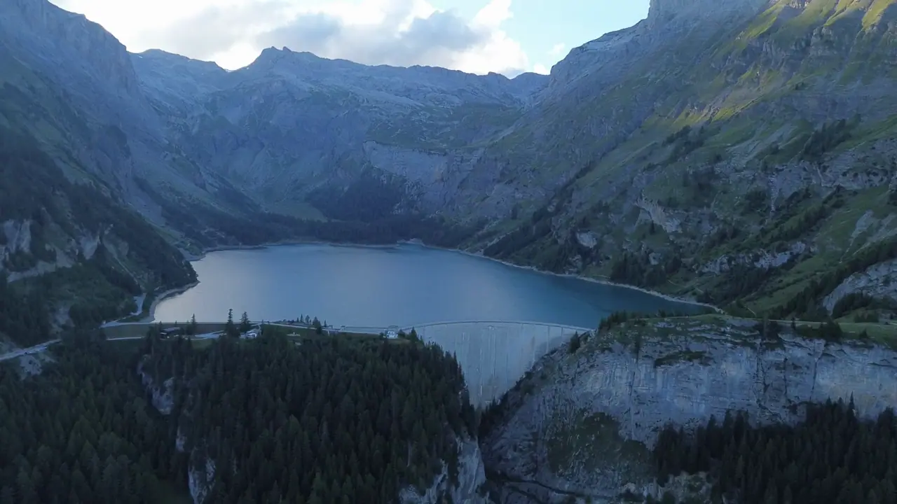 Aerial of the turquoise Lac de Tseuzier reservoir and dam in the Swiss Alps
