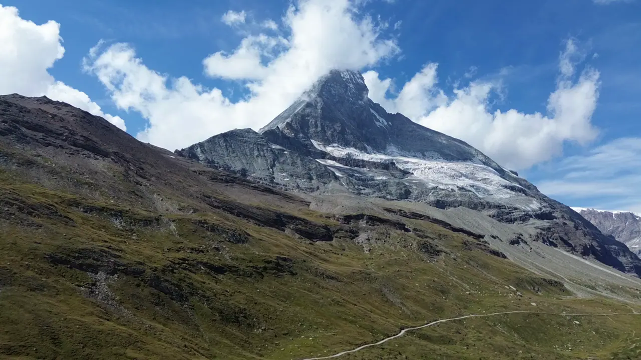 Aerial of the Matterhorn's pyramid summit above the Zermatt valley